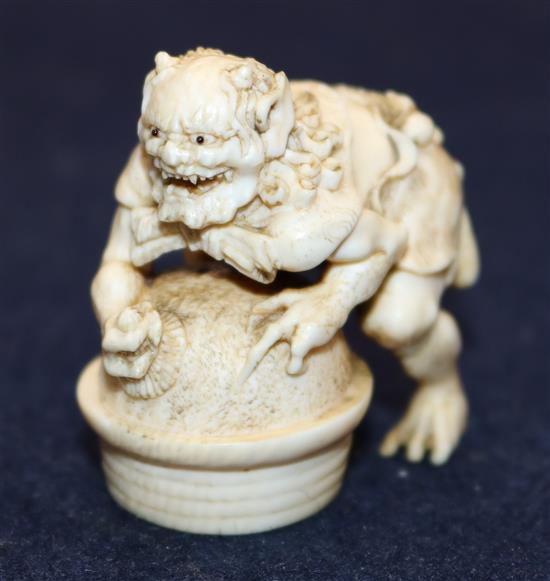 A Japanese ivory netsuke of an oni leaning on a cooking cauldron for rice, signed Tomomasa, 19th century, 4cm, loss to one toe